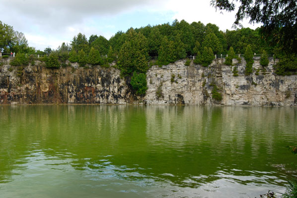 the quarry rock face reflected in the water