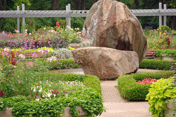 the large rock fountain at the centre of the pergola garden